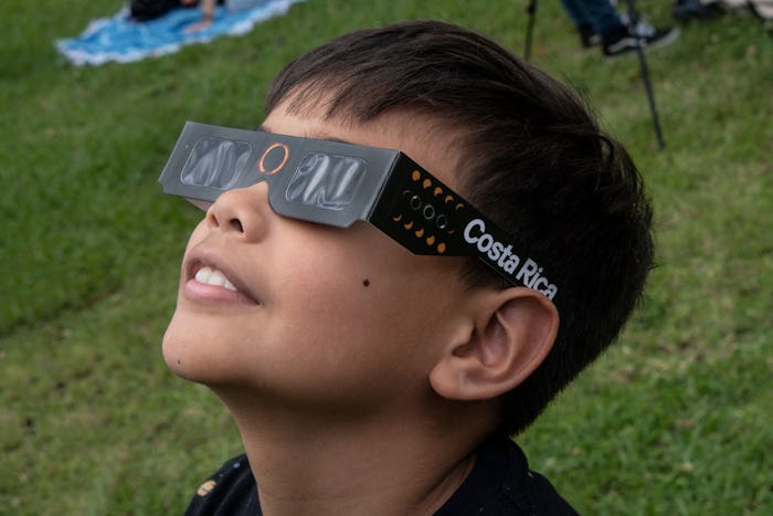A boy watches the annular eclipse of the sun at the planetarium of the University of Costa Rica (UCR...