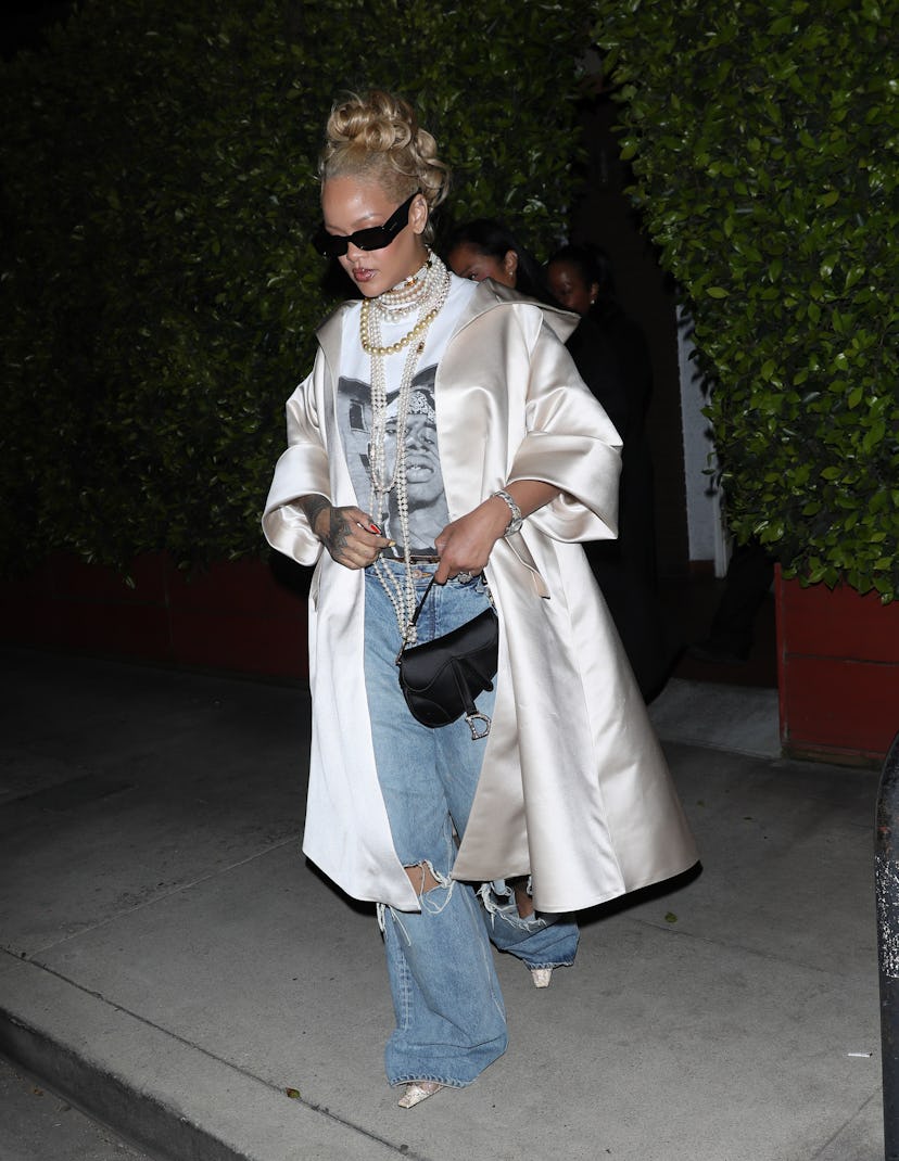 Rihanna wears a shirt, jeans, and satin coat at Giorgio Baldi restaurant on April 07, 2024. 