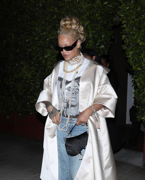 Rihanna wears a shirt, jeans, and satin coat at Giorgio Baldi restaurant on April 07, 2024.