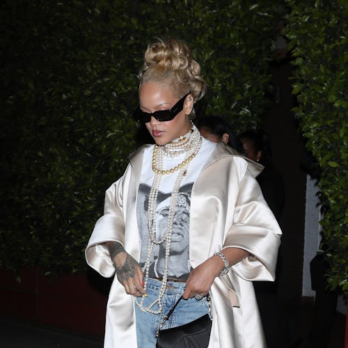 Rihanna wears a shirt, jeans, and satin coat at Giorgio Baldi restaurant on April 07, 2024.