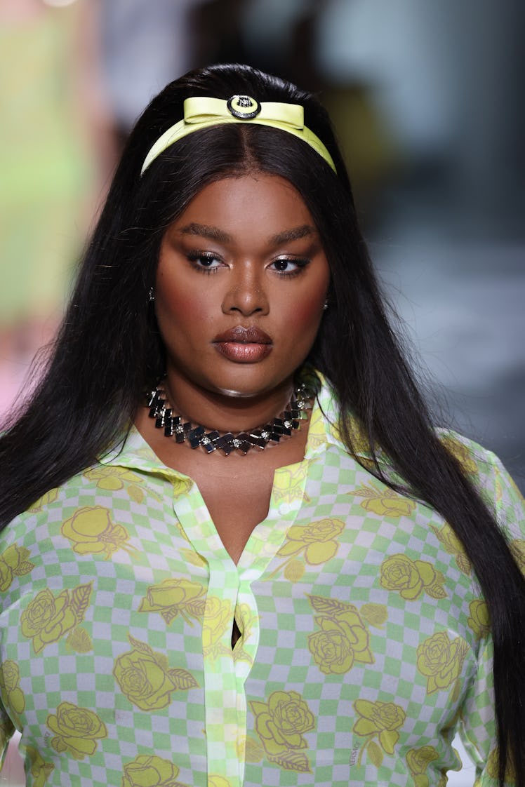 MILAN, ITALY - SEPTEMBER 22: Precious Lee, beauty detail, walks the runway at the Versace fashion sh...