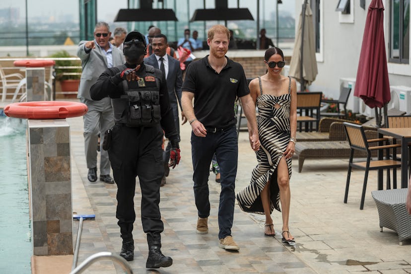 Britain's Prince Harry (C), Duke of Sussex, and Britain's Meghan (R), Duchess of Sussex, arrive for ...