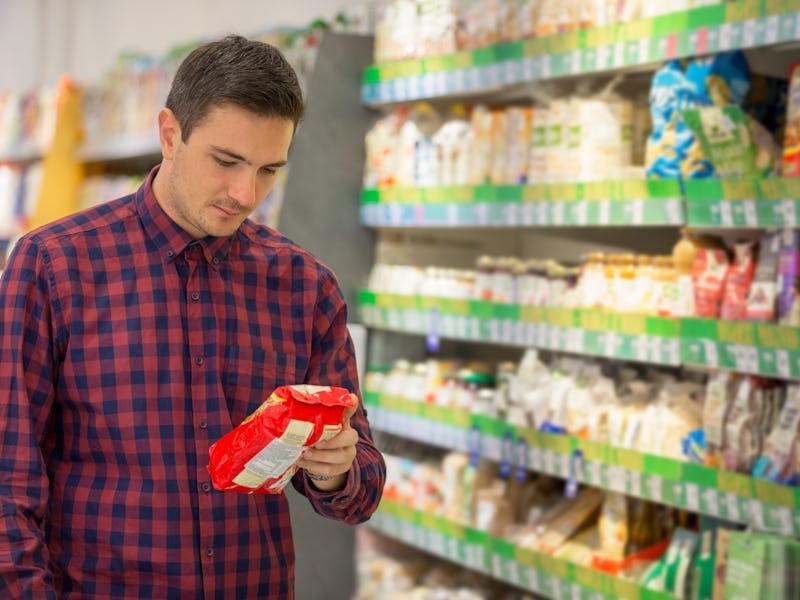 Man choosing snacks in supermarket