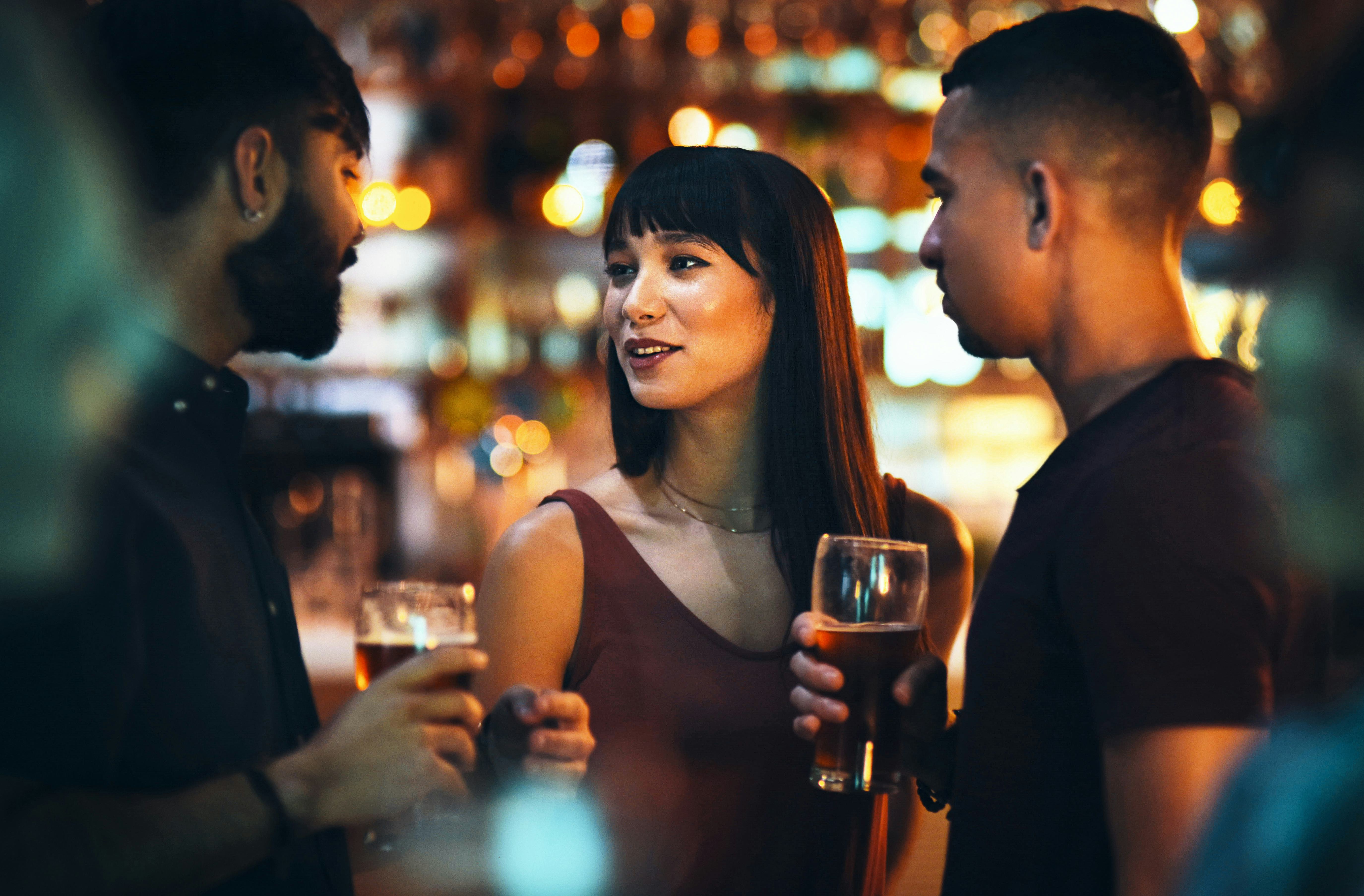 Friends at a club talking about the best pickup lines women have heard in real life