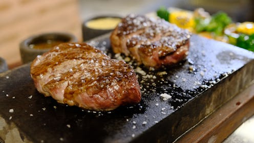 Cutting Oven Grilled beef steak with spices on stone