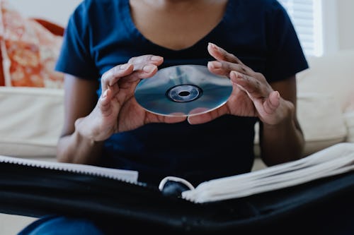 Close-up of unrecognizable black woman selecting a CD from her collection