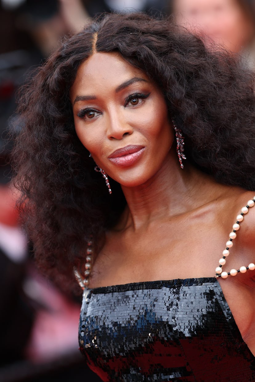 Naomi Campbell attends the Red Carpet at the 77th annual Cannes Film Festival wearing Chanel.