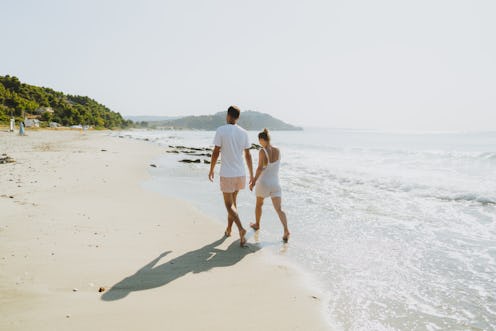 Photo of a romantic couple having a walk at the beach