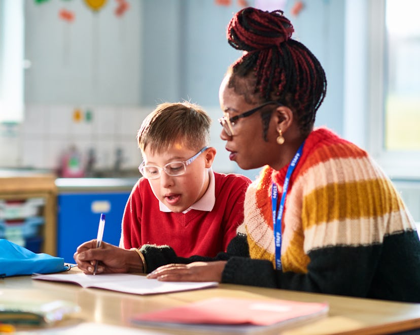 Teacher assisting child with special educational needs, in a story about teacher appreciation week 2...