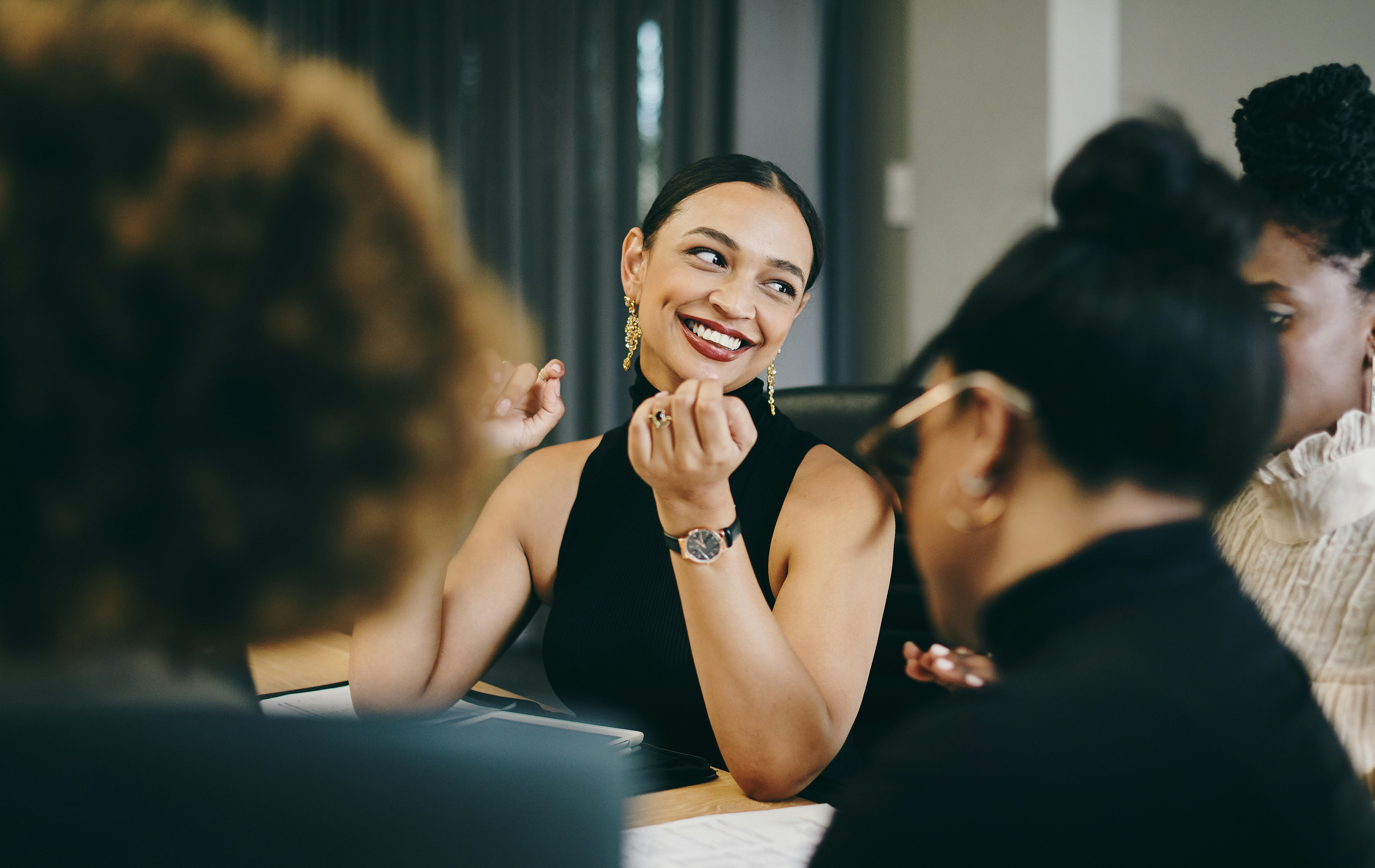 Woman telling good jokes at work with her coworkers