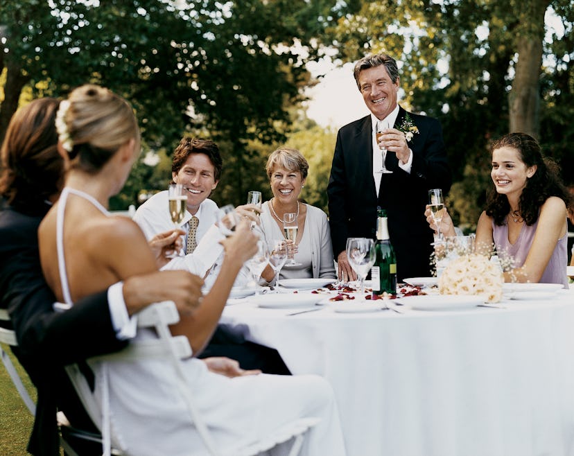 A father telling dad jokes while toasting at his daughter's wedding reception
