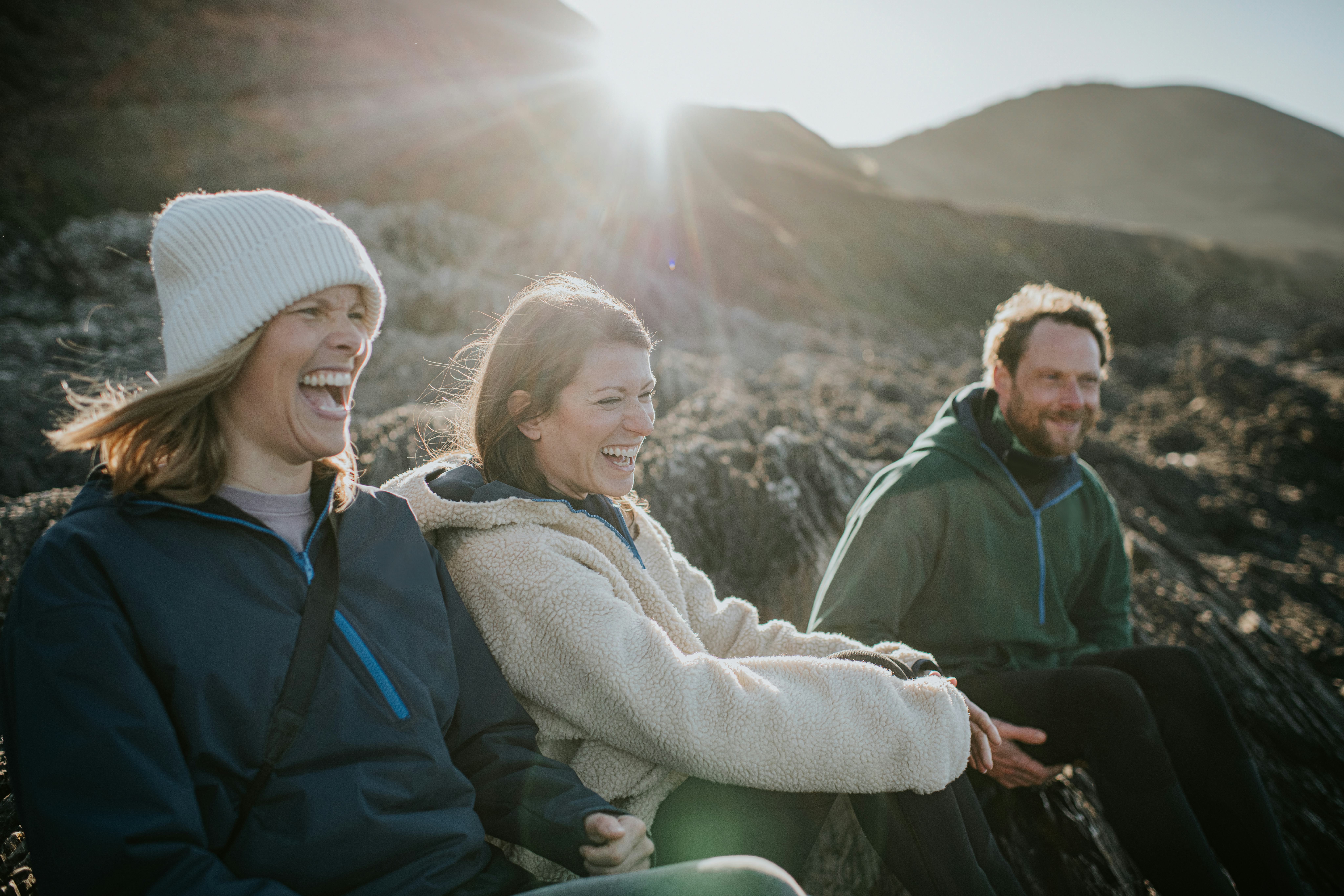 A group of friends outside asking each other funny Never Have I Ever questions