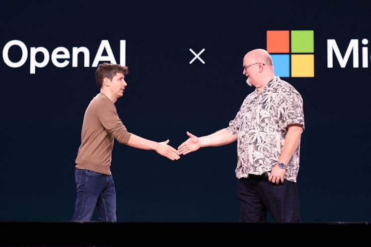 OpenAI CEO Sam Altman (L) shakes hands with Microsoft Chief Technology Officer and Executive VP of A...