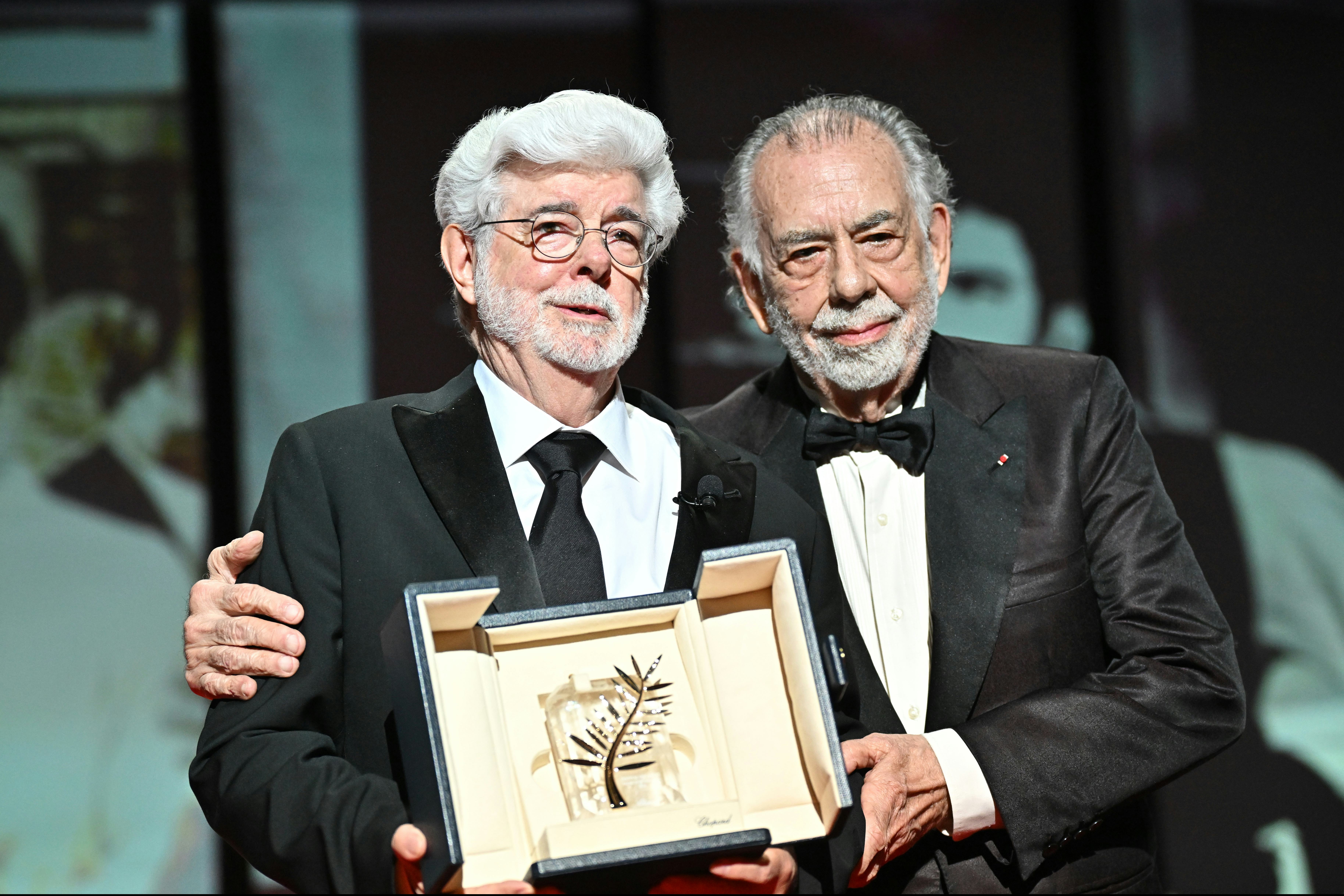 CANNES, FRANCE - MAY 25: Francis Ford Coppola (R) presents the Honorary Palme D’Or Award to George L...