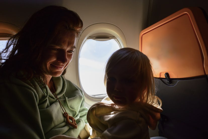 Child traveling on a plane with his parents