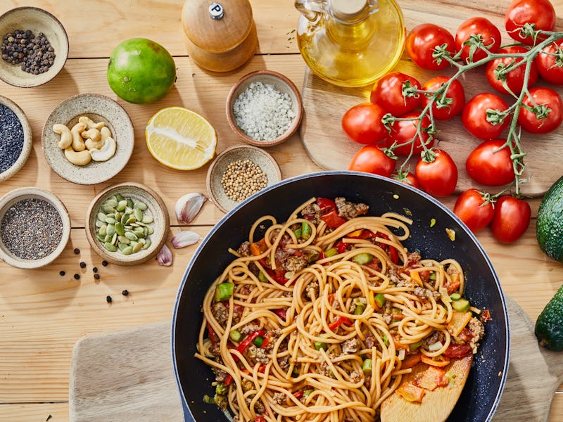 Healthy Bolognese protein spaghetti pasta preparation, made from minced beef meat, carrot, asparagus...