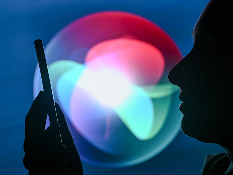 EDMONTON, CANADA - APRIL 28:
An image of a woman holding a cell phone in front of the Siri logo disp...
