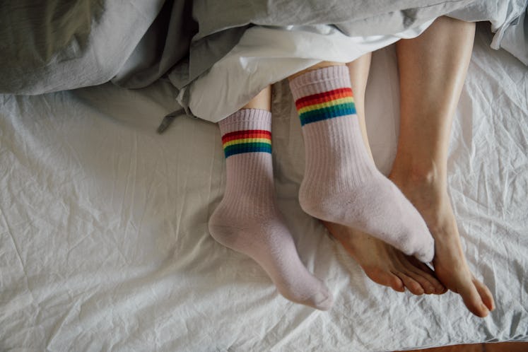 a couple in bed after having sex, which can affect your aura