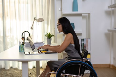 Asian Disabled Woman in Wheelchair Working with Computer on Desk in Office: Inclusive Workplace and ...