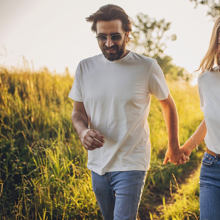 Parents out for a walk alone while kids stay home. They are enjoying the time alone.