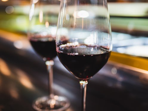 Close view of two glasses of red wine on the barcounter.