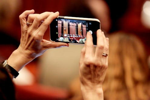 BARCELONA, SPAIN - JANUARY 28:  A journalist takes a pictures with her iPhone smartphone during a re...