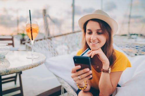 Woman making credit card payments from smartphone