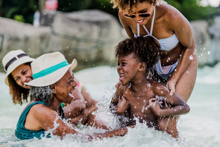 Family playing at water park pool