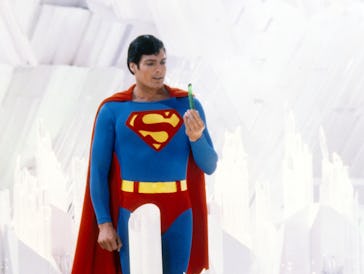 Superman, played by American actor Christopher Reeve (1952 - 2004), holds a green crystal at the For...