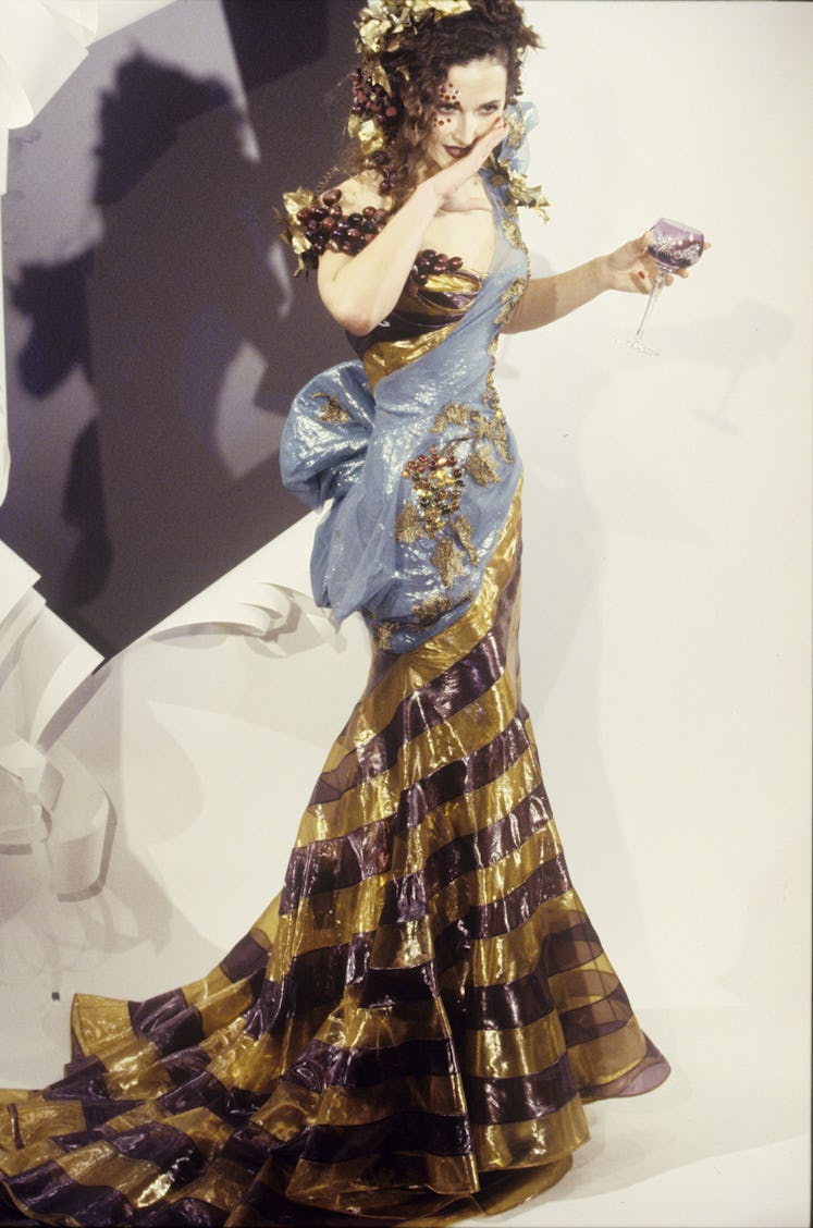 Off-the-shoulder gold and maroon striped gown with train and grapeleaf sash in the Christian Dior Sp...