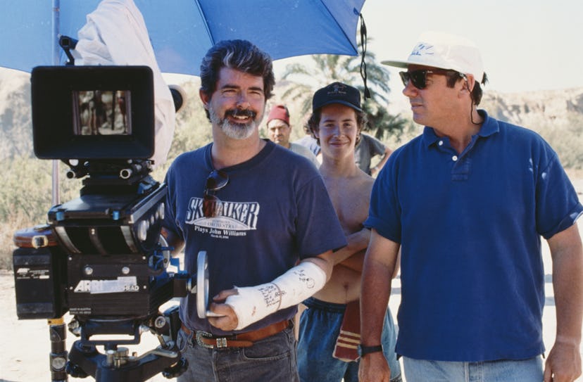 Executive producer George Lucas (left) wearing a plaster cast and a Skywalker Symphony Orchestra t-s...