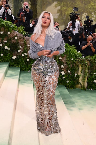 Kim Kardashian wearing a cardigan with her gown at the 2024 Met Gala.