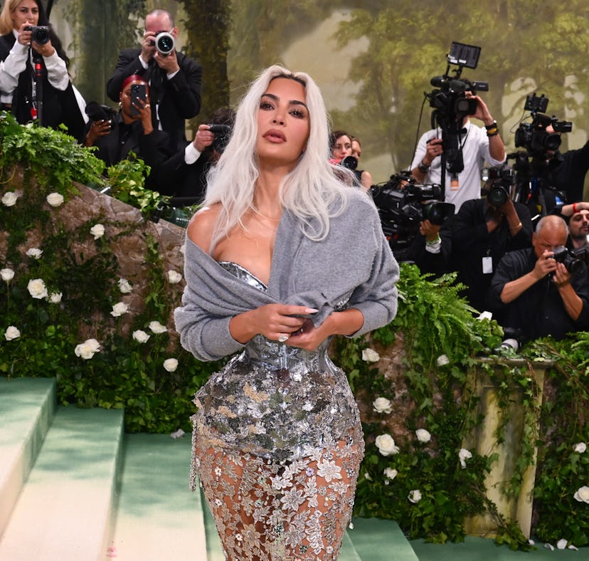 Kim Kardashian wearing a cardigan with her gown at the 2024 Met Gala.