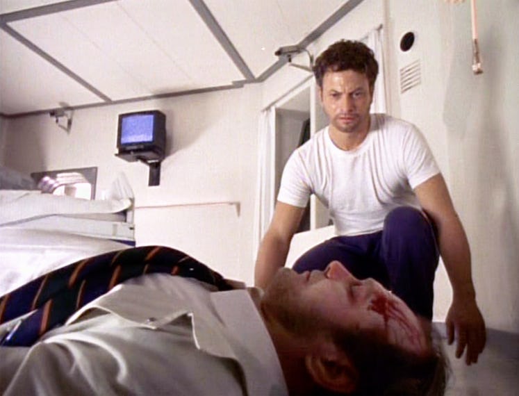 Gary Sinise (as Stu Redman) crouches toward Sherman Howard (as Dr. Dietz) in Episode 1 of 'The Stand...