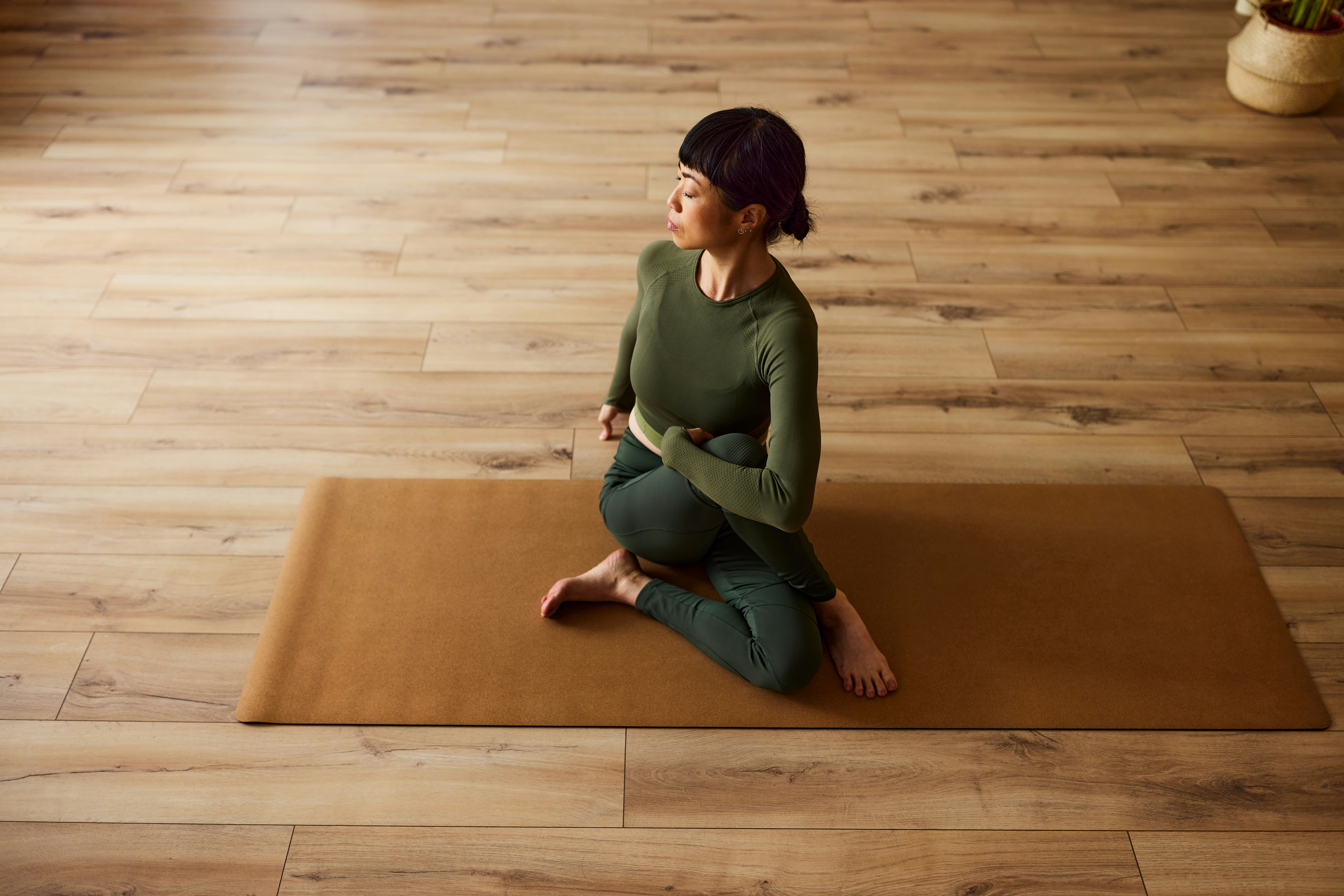 A woman doing yoga and listening to positive vibes quotes for affirmations