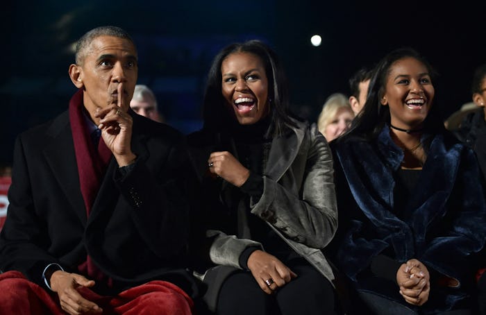 US President Barack Obama, First Lady Michelle Obama and their daughter Sasha (R) react during the N...
