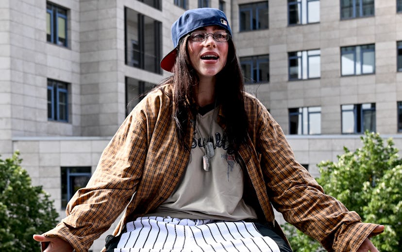 07 June 2024, Berlin: The American singer Billie Eilish is sitting on a ledge of a staircase railing...