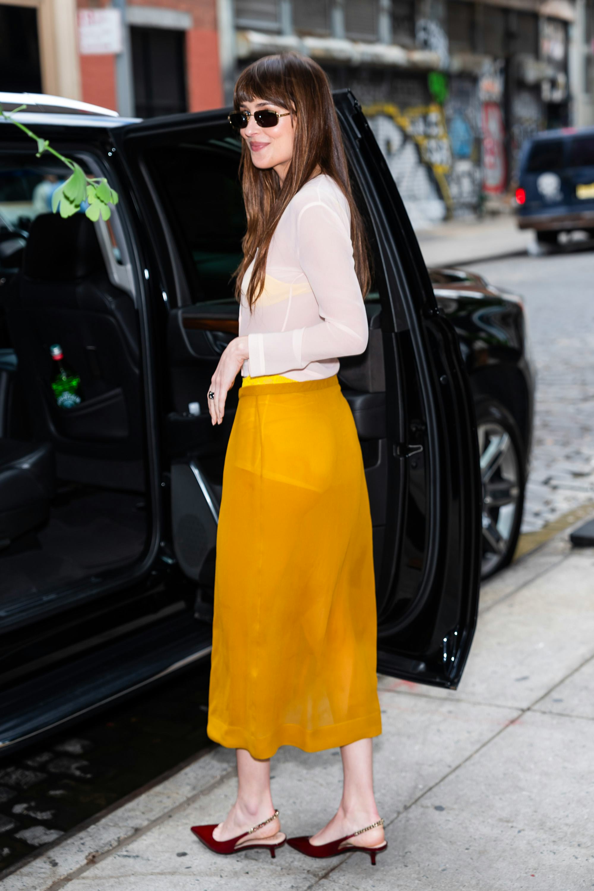 Dakota Johnson wears a sheer white top and sheer yellow skirt in SoHo on June 10, 2024 in New York C&hellip;