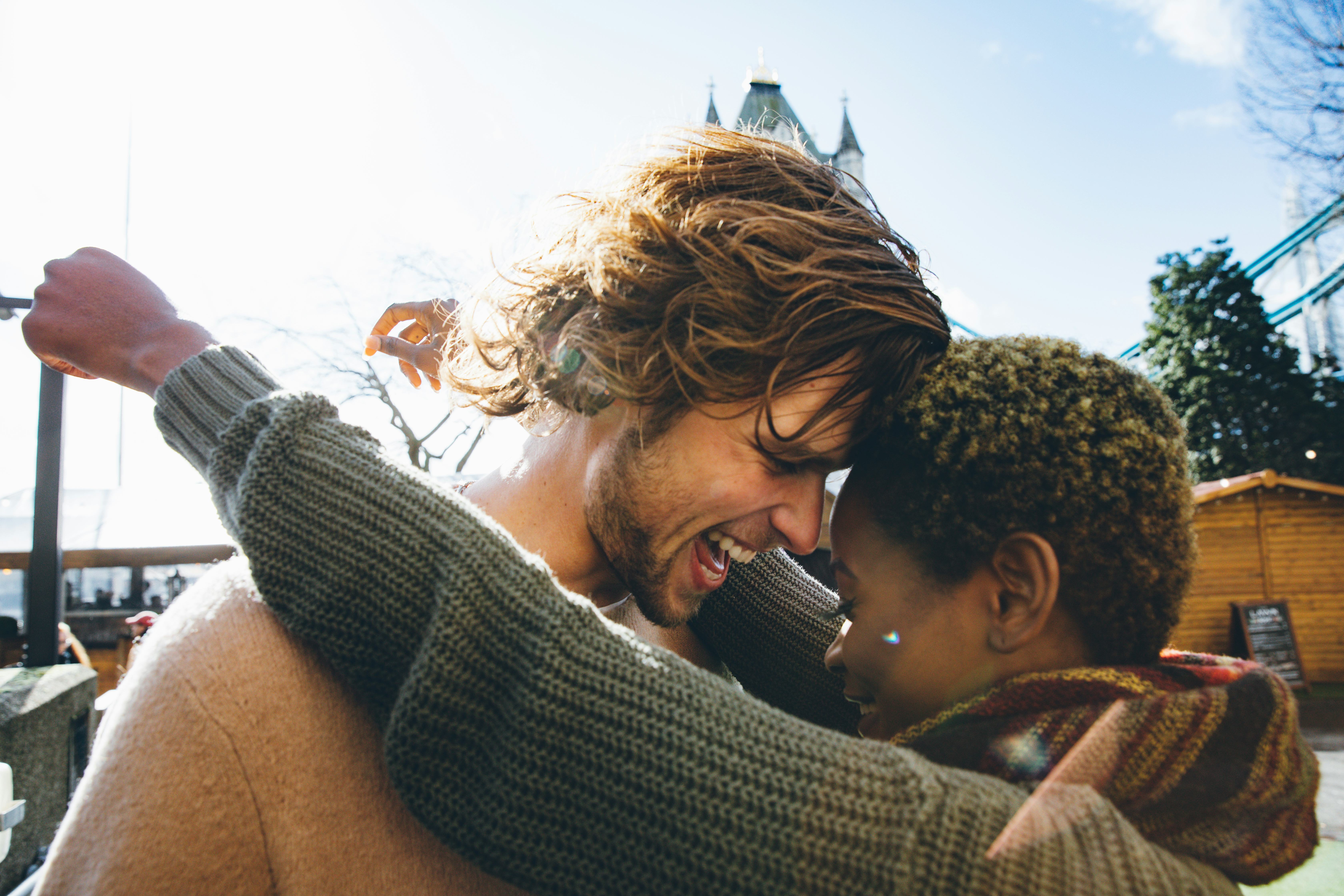 A woman trying some new nicknames on her boyfriend and snuggling into his forehead.