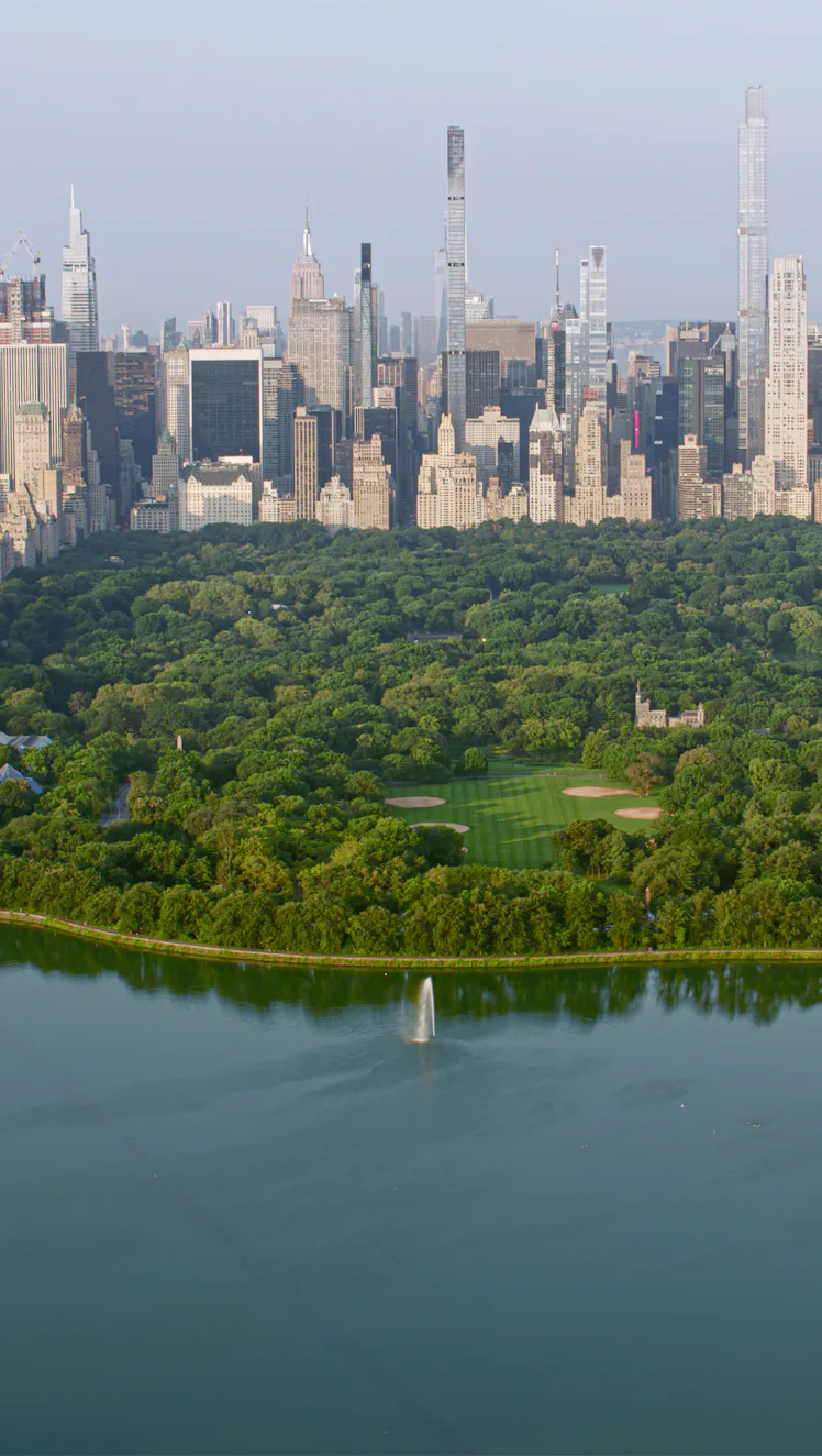 Aerial view of Central Park with Central Park Reservoir surrounded by modern skyscraper in New York ...