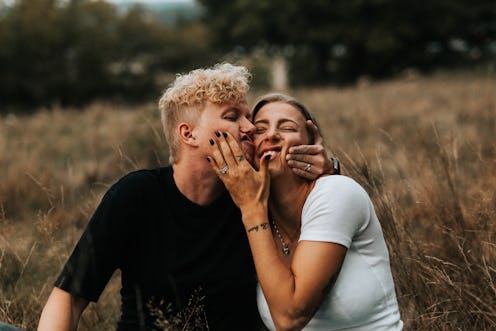 A young couple squishes each other's faces after the girlfriend gives the boyfriend a silly nickname...