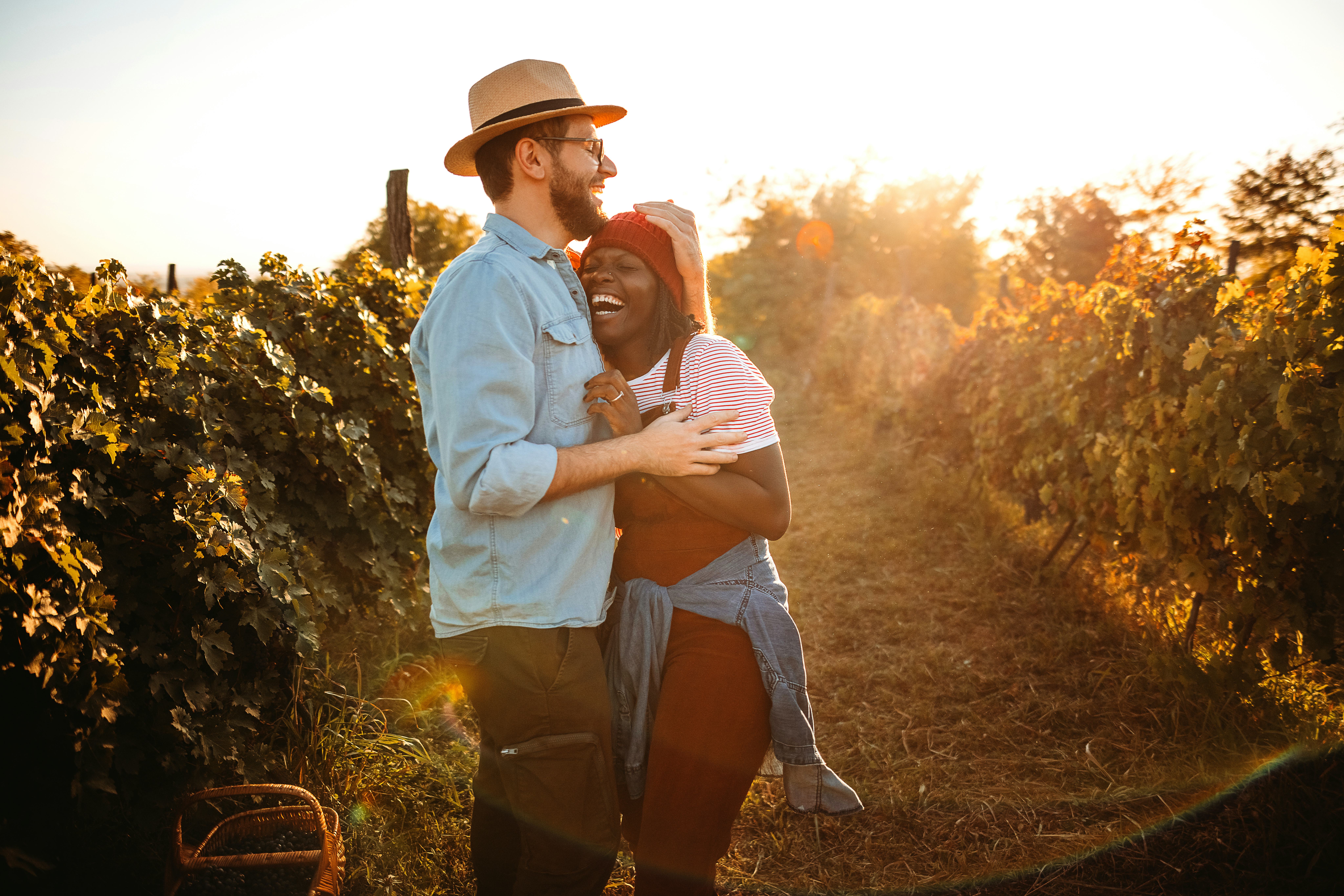 A playful couple give each other girlfriend and boyfriend nicknames in a vineyard.