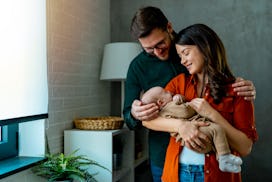 Young cheerful parents are happy for the baby
