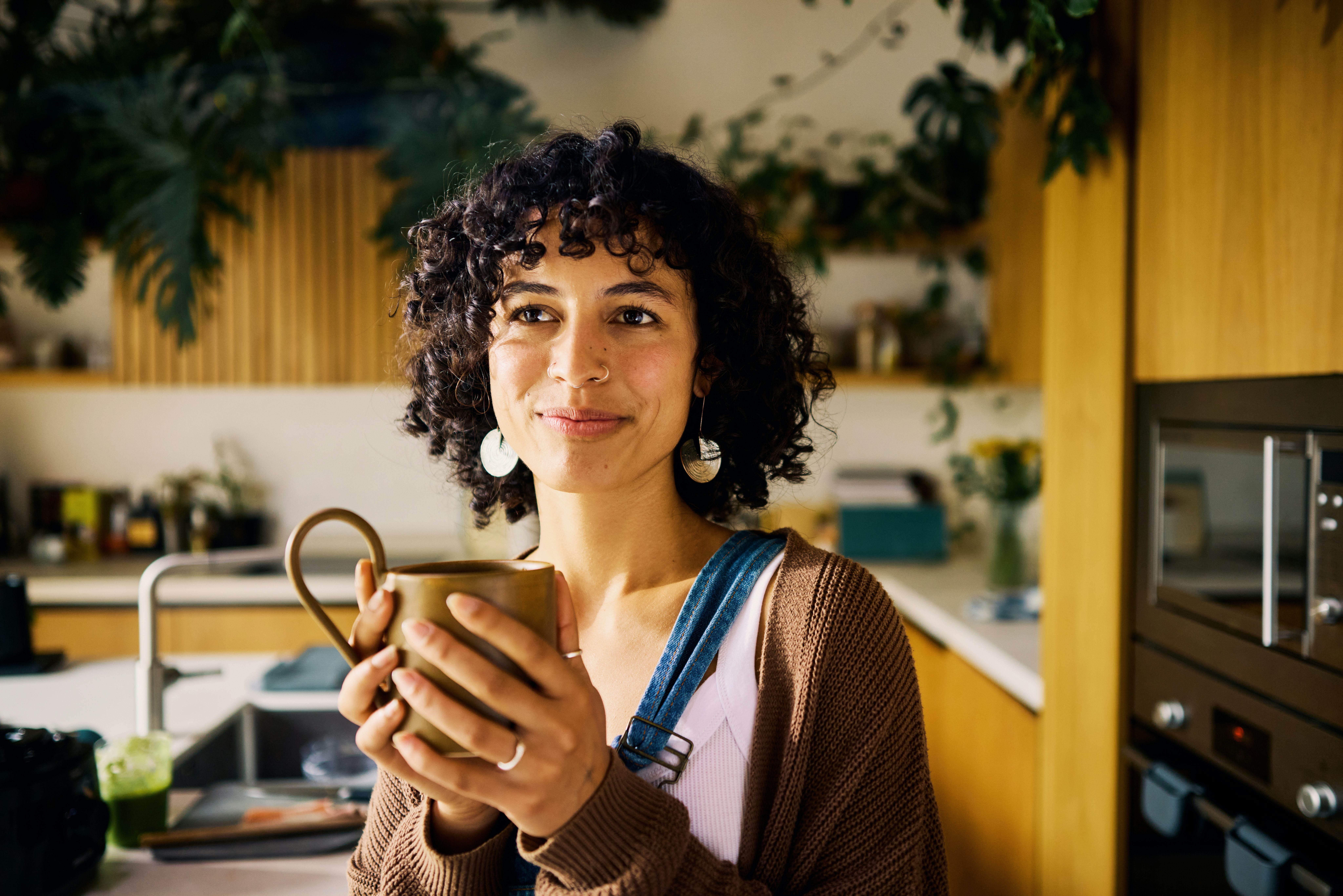 A woman stands in her kitchen holding a coffee mug and contemplates the answers to some tricky riddl&hellip;