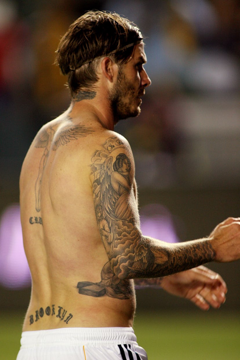 David Beckham has an iconic lower back tattoo.