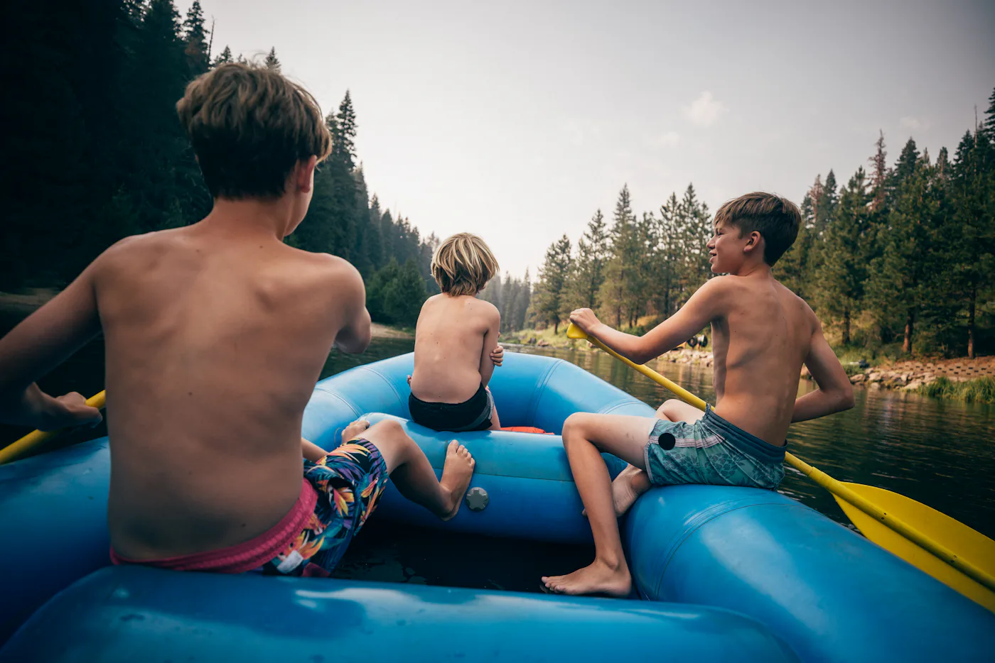 USA, California, Boys (8-9, 12-13) rafting on Truckee river