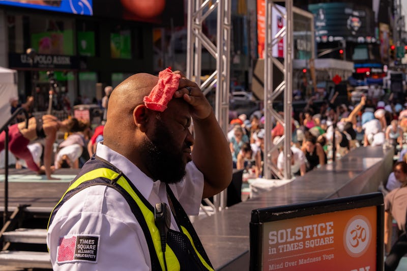A Times Square Alliance Public Safety Officer wipes away sweat in Times Square during high temperatu...