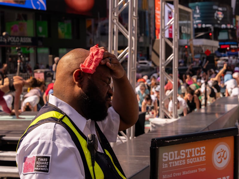 A Times Square Alliance Public Safety Officer wipes away sweat in Times Square during high temperatu...