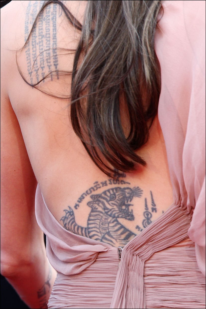 Angelina Jolie has an iconic lower back tattoo.