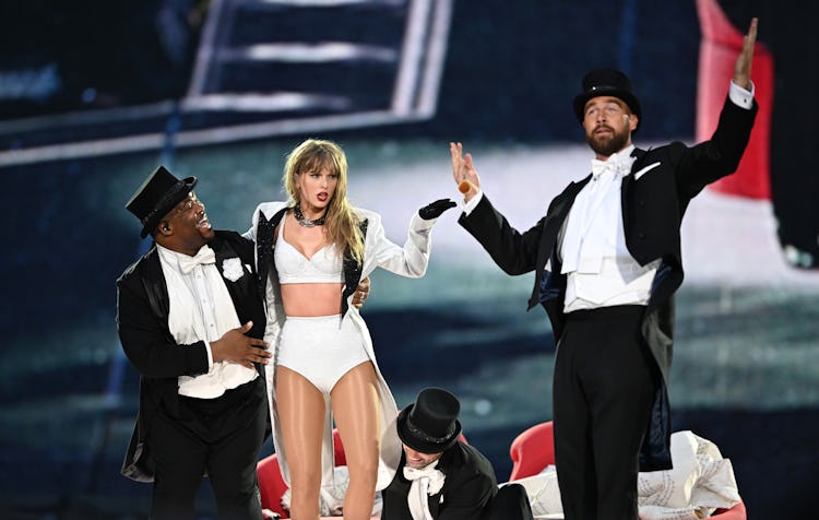 Taylor Swift is joined on stage by Travis Kelce (R), during "Taylor Swift | The Eras Tour" at Wemble...